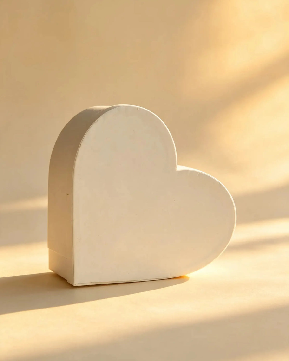 Ivory heart-shaped cardboard gift box, front angled view