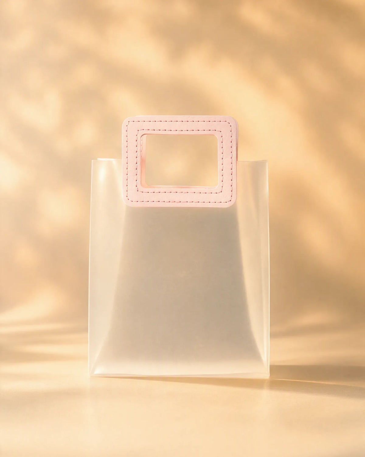 Clear PVC gift bag with pink square handle, size XL, front view