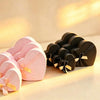 Pink and black heart-shaped nesting gift boxes with dot-grid pattern and satin ribbon bows, shown together