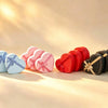 Heart-shaped gift boxes in skyblue, pink, red, and black, each tied with a ribbon bow, grouped in sets of three.