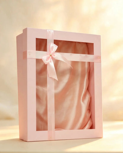 Blush pink gift box with clear window, satin ribbon bow, and pink fabric lining