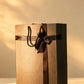 Bronze bag-style gift box with black ribbon bow and rope handles