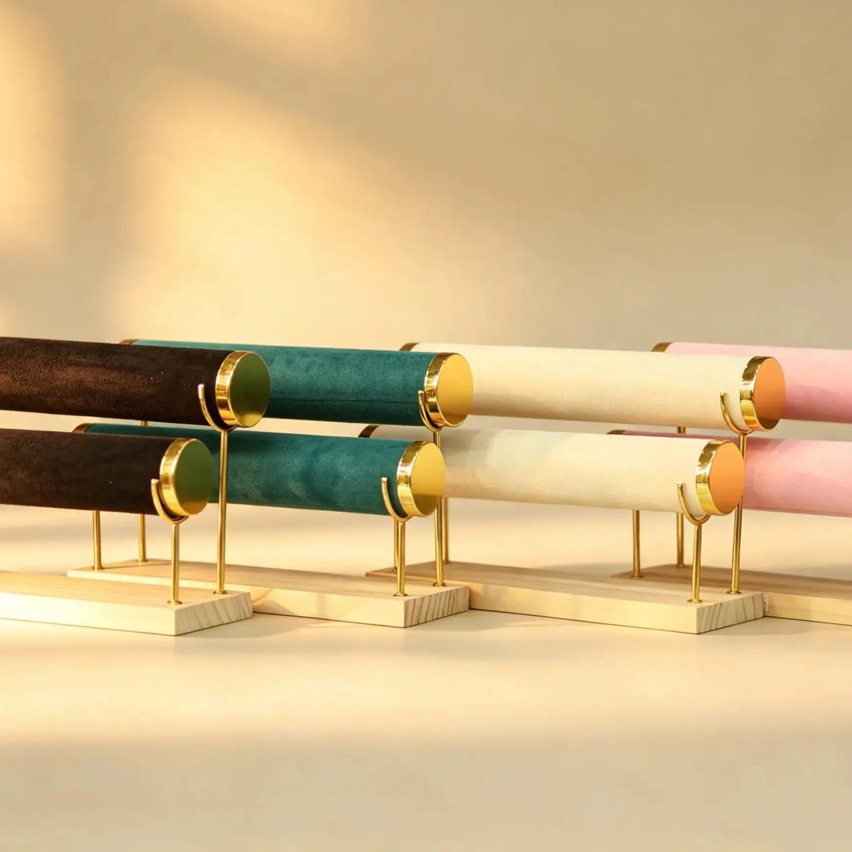 Double-tier bangle display stand with velvet-wrapped bars in assorted colors on a wood base