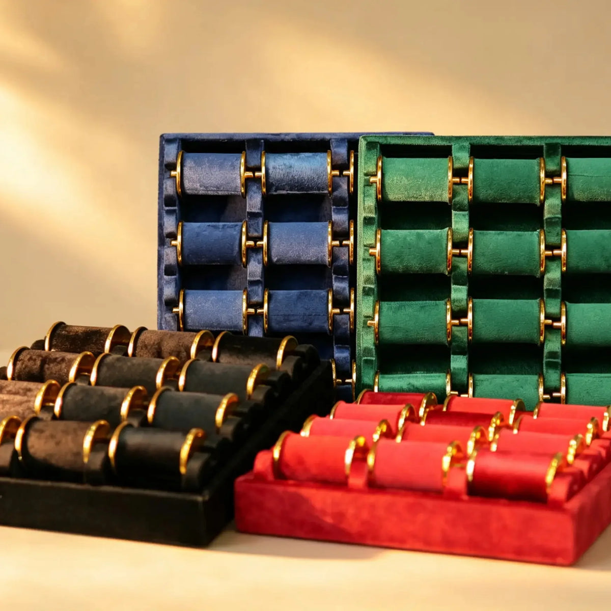 Navy, green, black and red velvet bangle display trays with gold-tone roll hardware