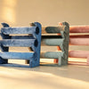 Three velvet bangle stands in blue, sage green, and pink, shown side by side
