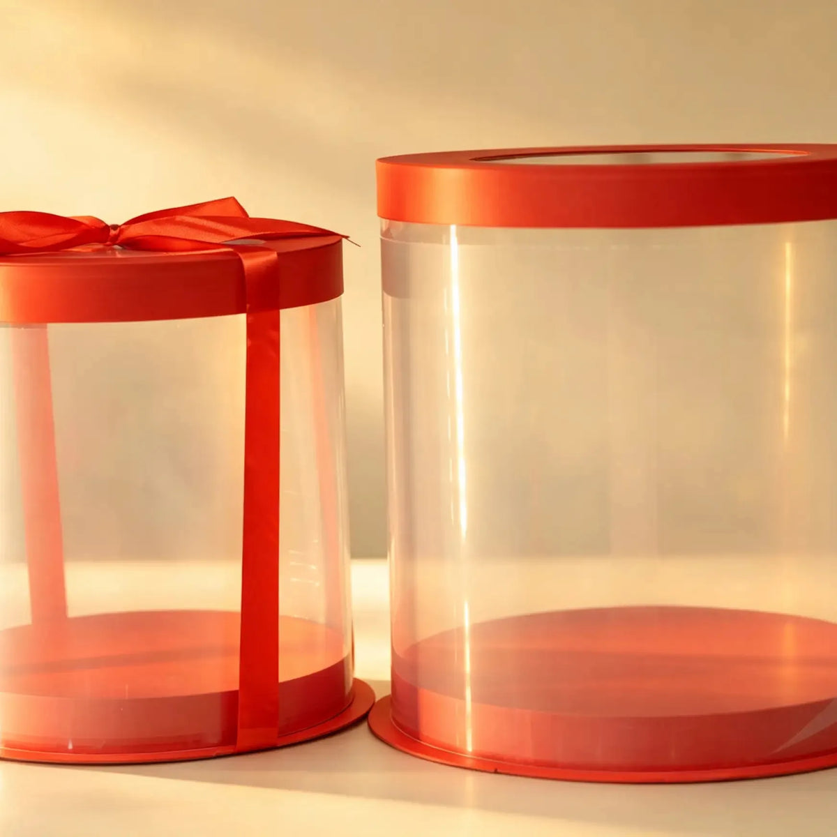 Red and clear PVC cake box set, two nested sizes tied with a red ribbon