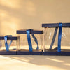 Three navy blue-trimmed clear PVC cake boxes nested together with satin ribbon ties