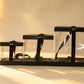 Three black-trimmed clear PVC cake boxes nested together with black satin ribbon ties
