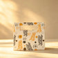 Cream gift bag printed with 'Happy Birthday' text and party icons, ribbon handle