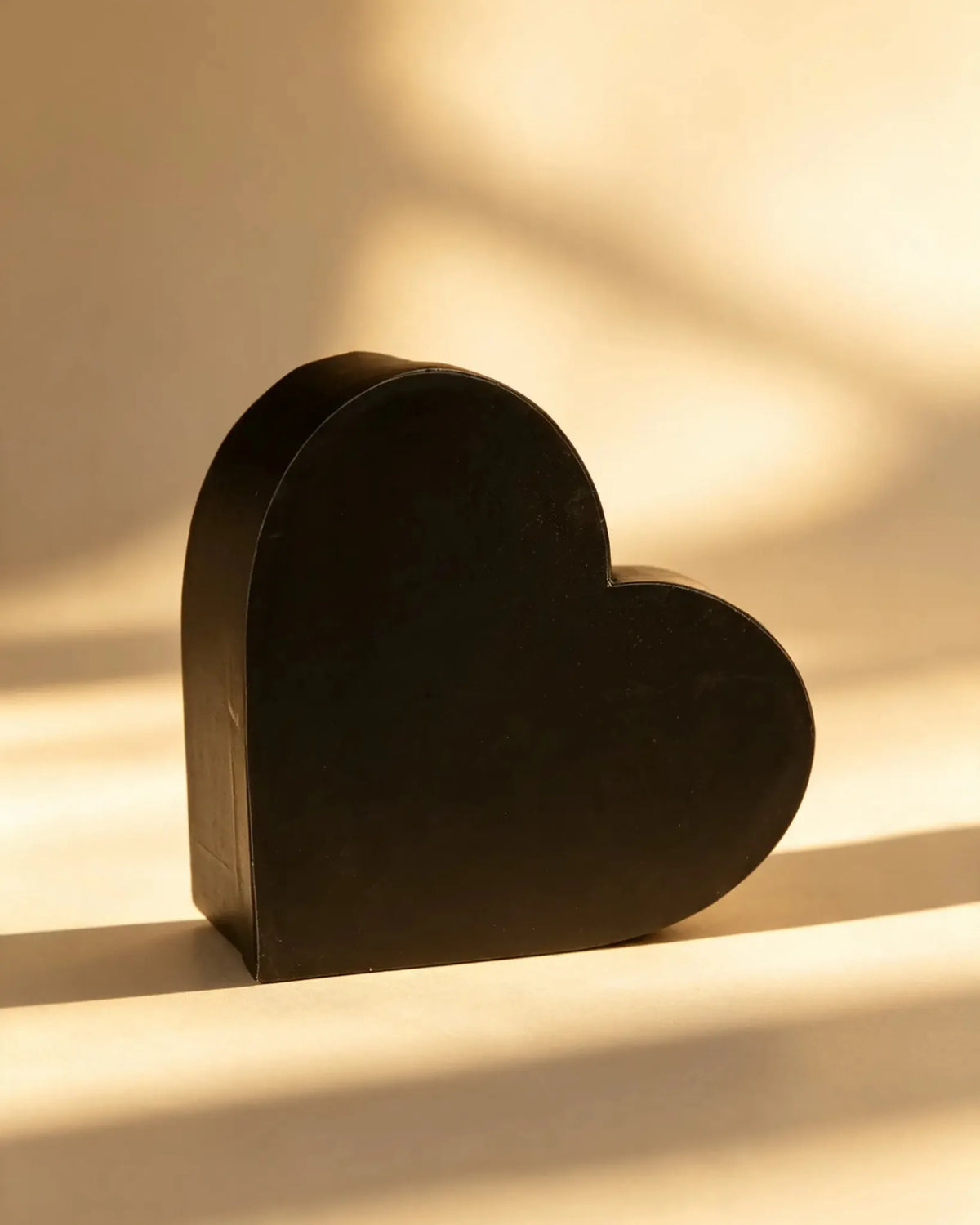 Black heart-shaped cardboard gift box, front angled view