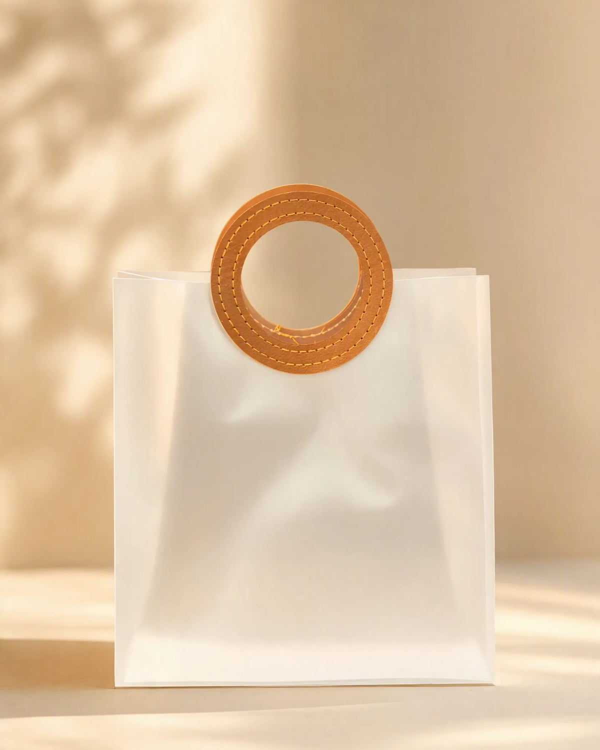 Small frosted PVC gift bag with round brown stitched handle