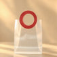 Clear PVC gift bag shown close-up, focused on the red round handle