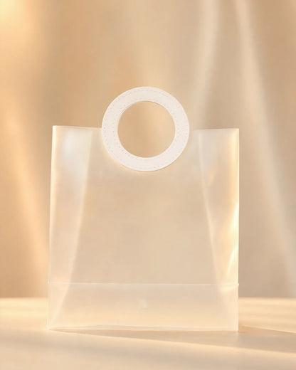 Frosted white PVC gift bag with round stitched handle, front view