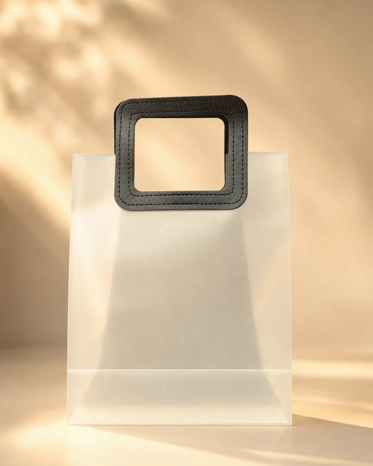 Frosted translucent PVC gift bag with black square handle, close on handle