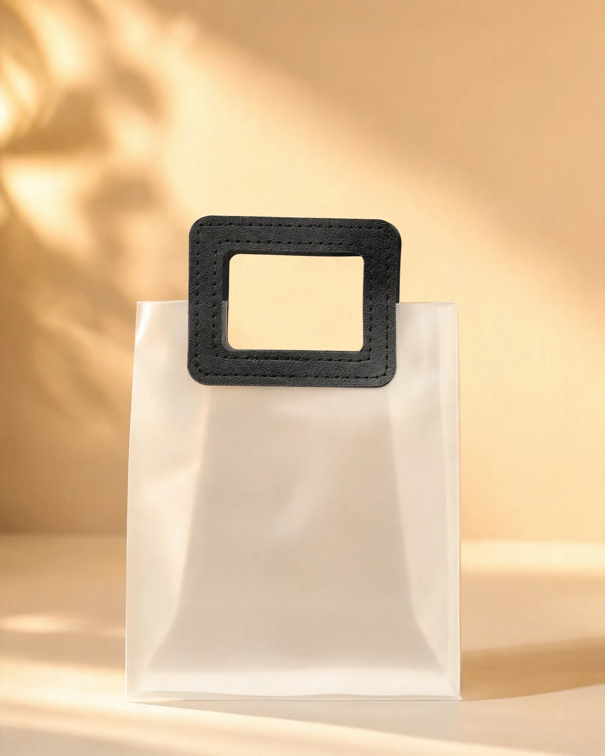 Frosted PVC gift bag with black square handle standing on flat bottom