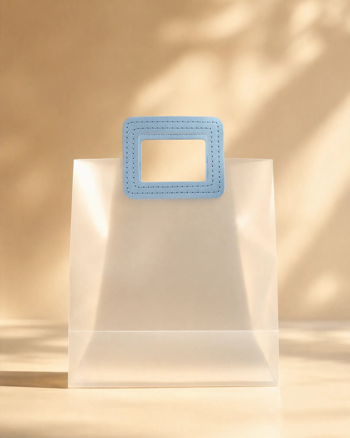 Frosted PVC tote-style gift bag with a stitched blue handle