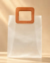 Frosted PVC gift bag with tan square handle, front view