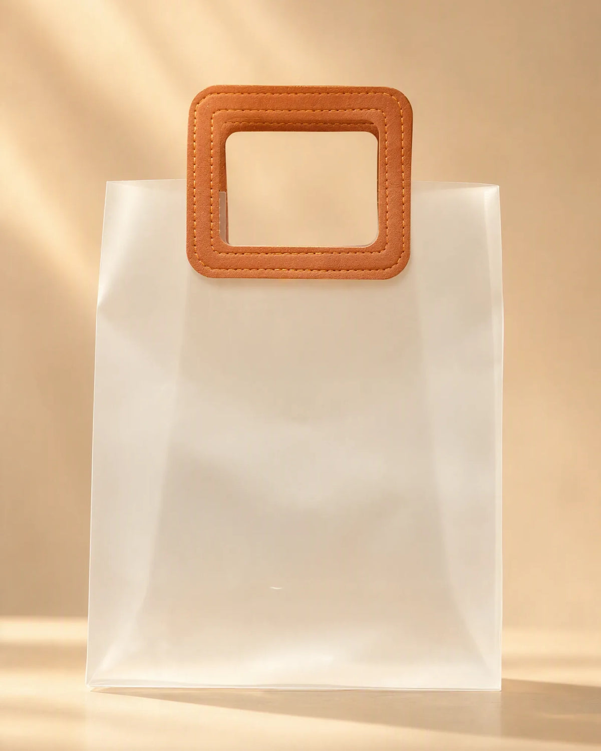 Frosted PVC gift bag with tan square handle, front view