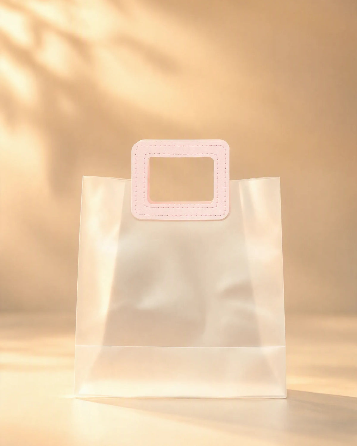 Clear PVC gift bag with pink square handle, size M, front view
