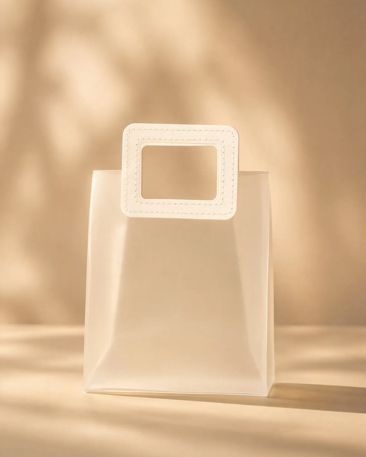 Translucent PVC gift bag with square carry handle, straight-on view