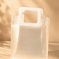 Frosted PVC gift bag with stitched square handle, close front view