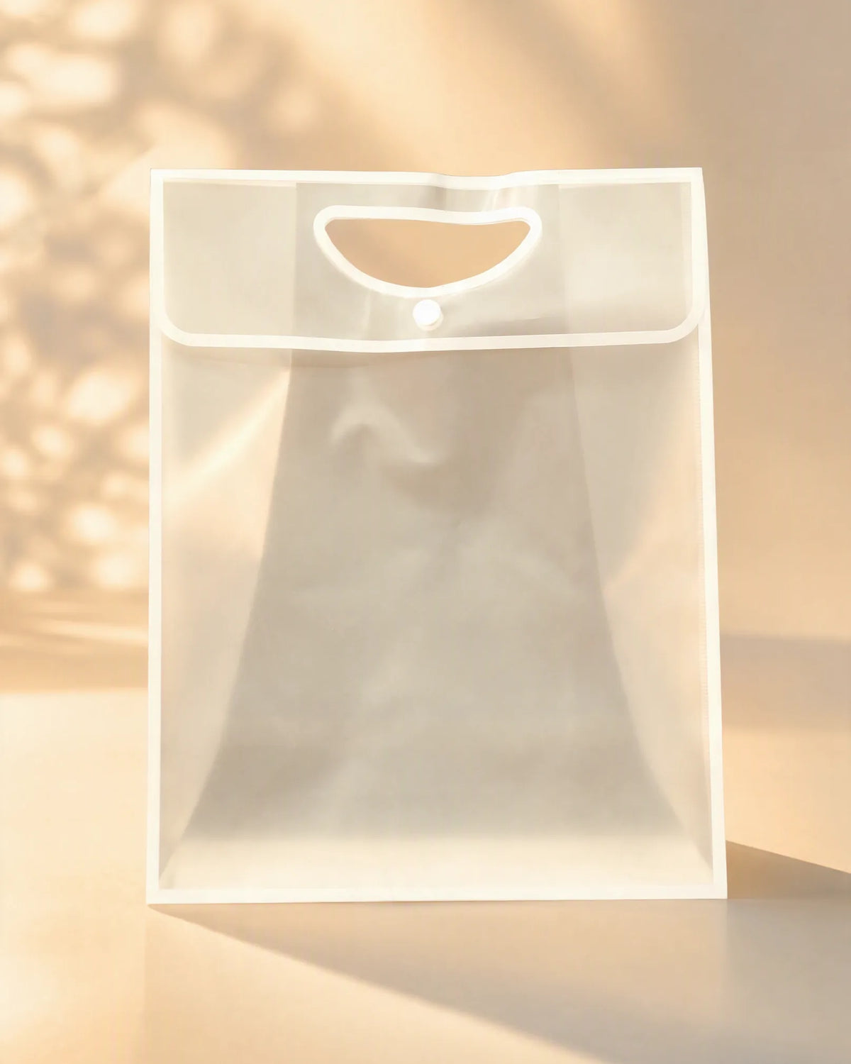 Frosted white PVC gift bag with cutout handle and button closure