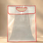 Clear PVC gift bag with red trim, cutout handle, and button closure