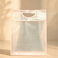 Frosted pink PVC gift bag with cutout handle and button closure