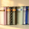 Green PVC gift box with clear lid and ribbon tie, shown with other colour options