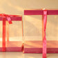 Clear PVC cake boxes with pink trim and pink ribbon bow, large and small size