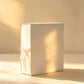 Ivory white gift box with matching ribbon bow, angled view