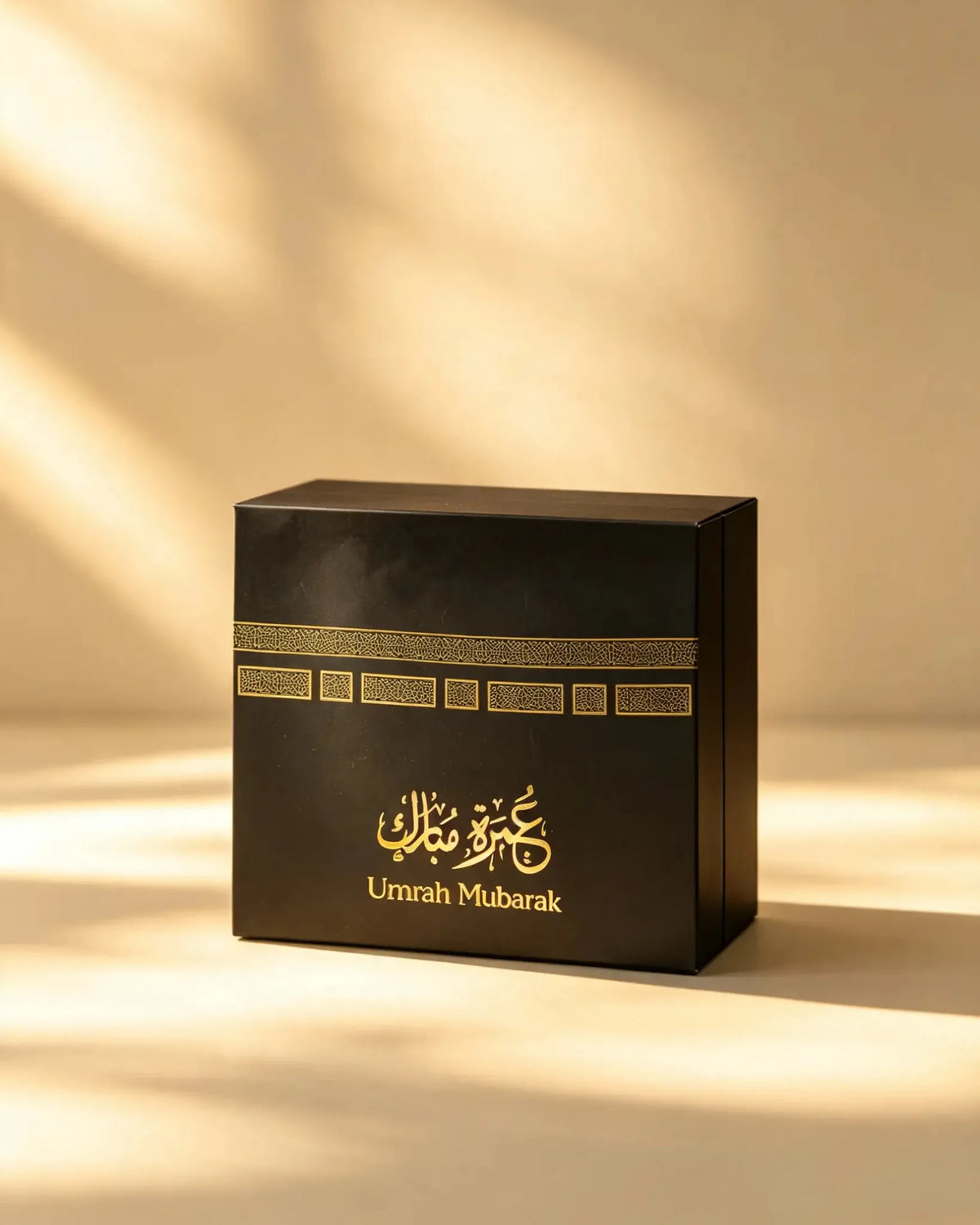 Black Umrah Mubarak gift box with gold geometric border pattern, front view