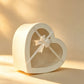 Ivory heart-shaped gift box with clear window and cream satin ribbon bow